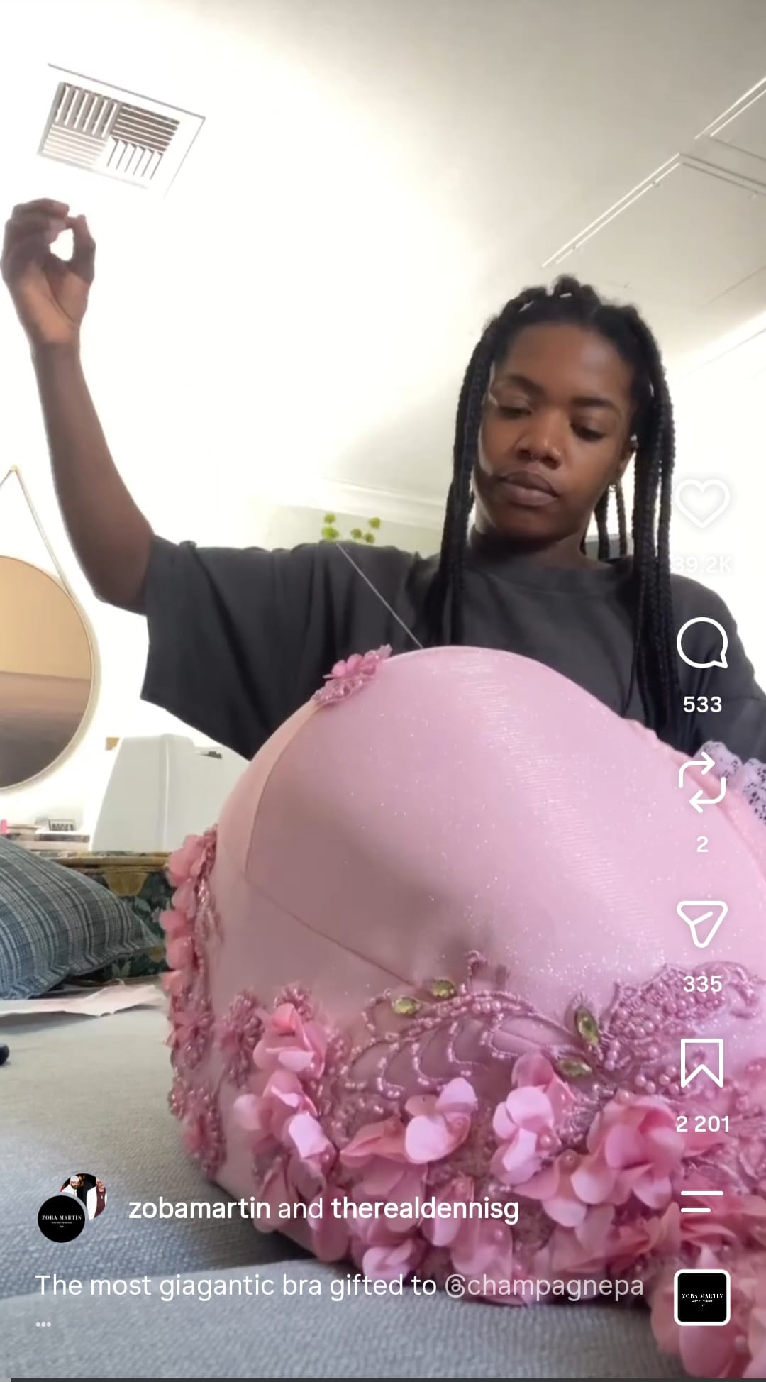 Chizoba Martin hand-sews beading and pink 3D flowers onto the giant Zoba Martin bra made for Drake's It's all a Blur tour concert.