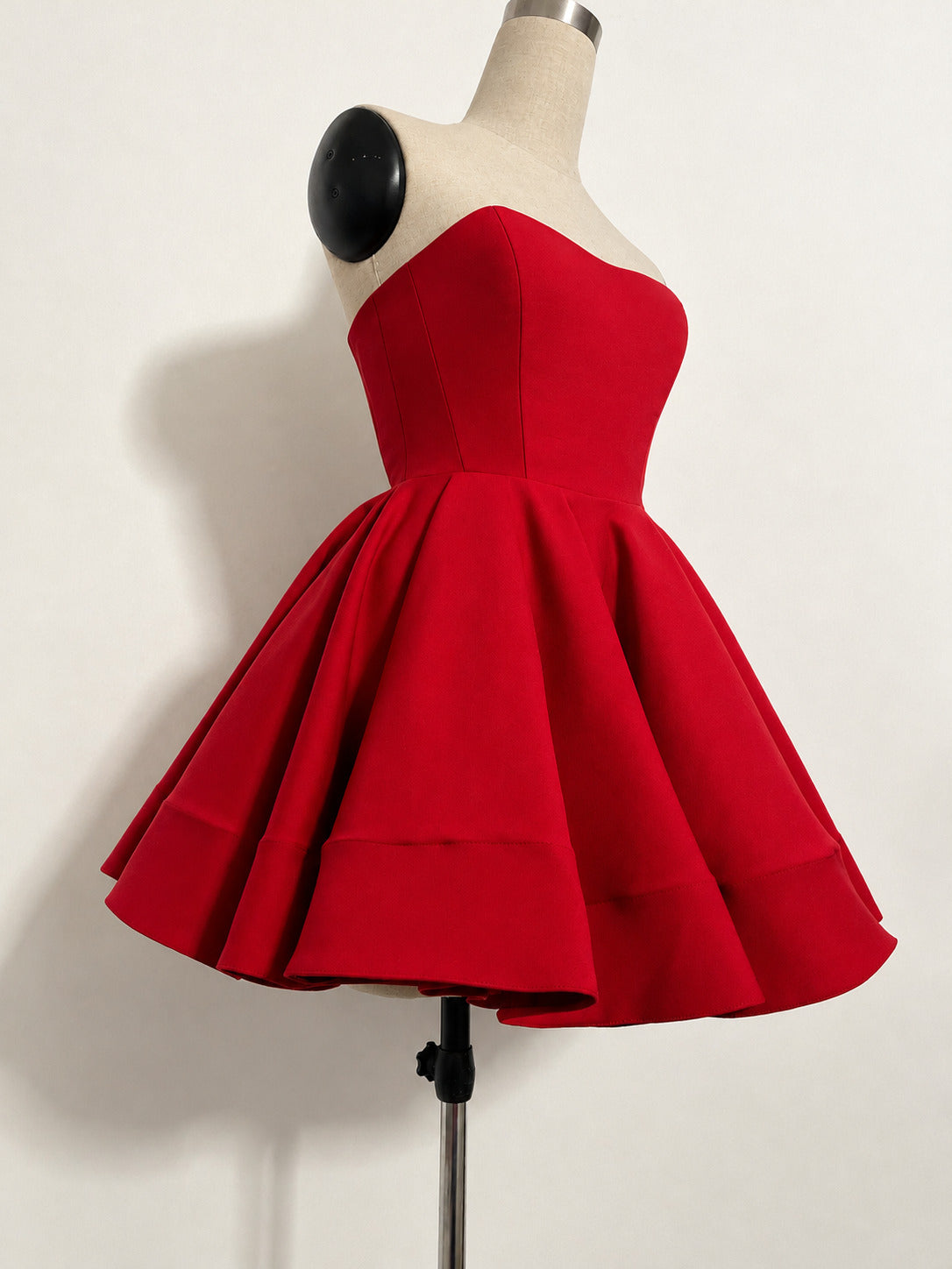 Scarlet strapless Zoba Martin dress with a sweetheart neckline and full flared mini skirt, on a mannequin.